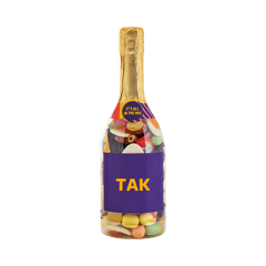Champagneflaske fyldt med farverigt slik med teksten TAK på etiketten. Gaveidé fra SlikEkspressen.