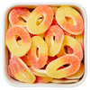 Fersken Ringe fra Candy Plus – orange og gule vingummiringe med hvid skumbund og sukkerdrys.