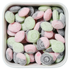 Støvede bolsjer i grøn, pink og sort med smag af hindbær, pære og saltlakrids – Kometer fra Grahns.